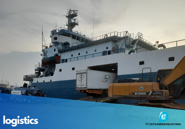 Telecommunications tower in a rural area with mountains in the background